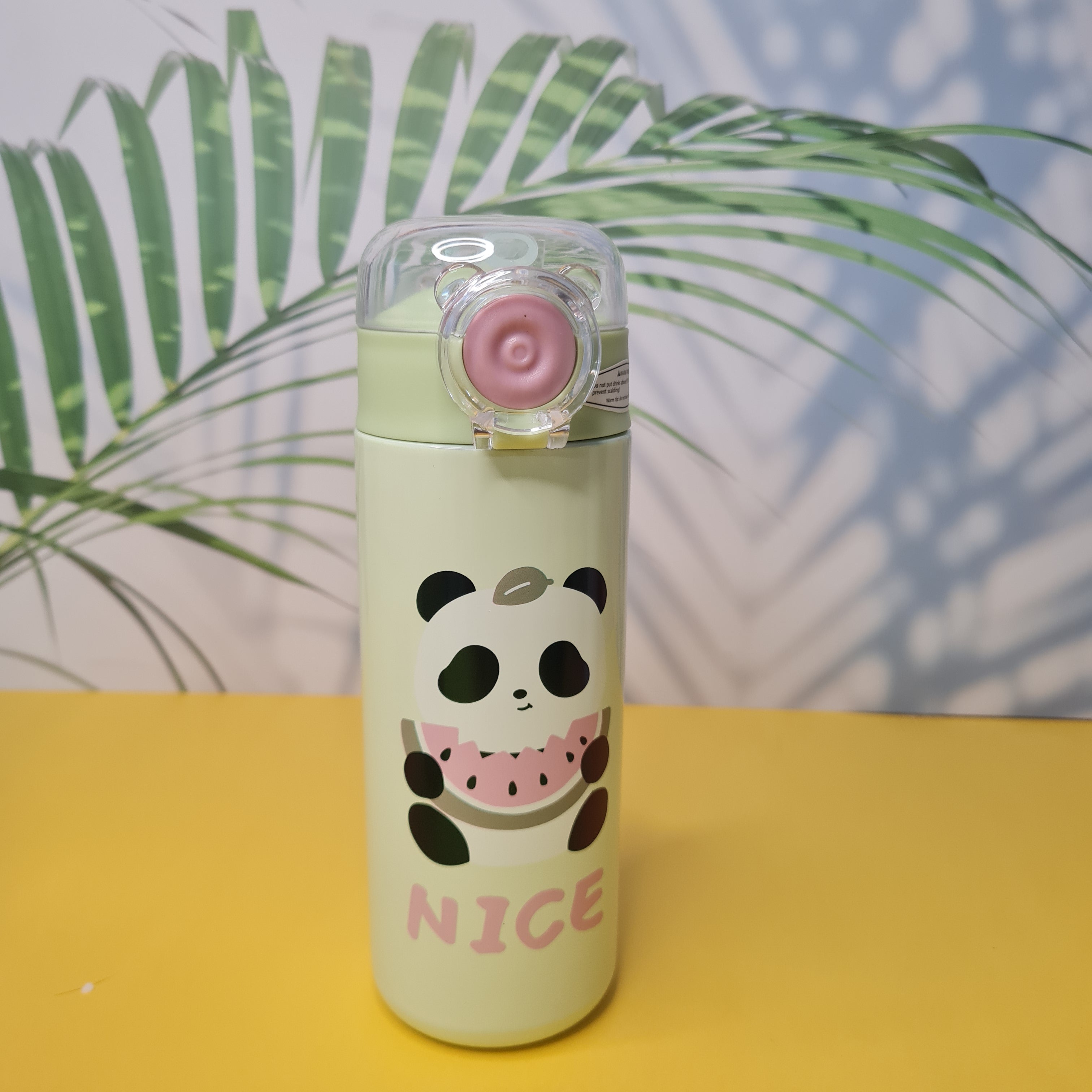 Bottle with panda design and 'NICE' text on a yellow and blue background